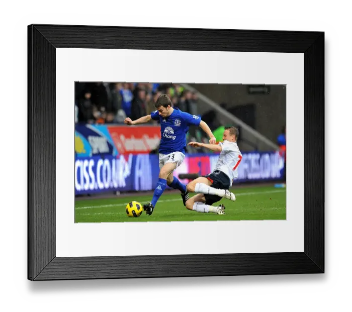 Framed Print : Intense Battle for Ball Possession: Seamus Coleman vs. Matthew Taylor, Everton vs. Bolton Wanderers, Barclays Premier League (February 13, 2011)