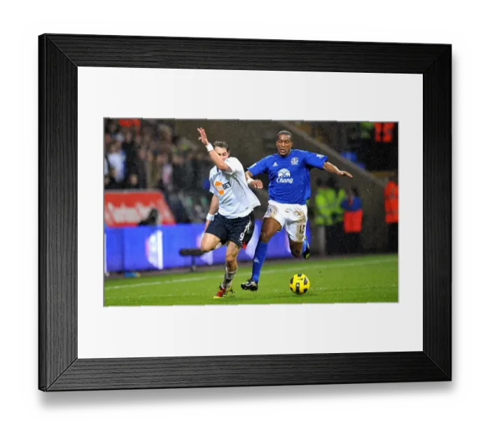 Framed Print : Intense Battle for Ball Possession: Distin vs Elmander, Everton vs Bolton Wanderers, Barclays Premier League (2011) Framed Print : Intense Battle for Ball Possession: Distin vs Elmander, Everton vs Bolton Wanderers, Barclays Premier League (2011)