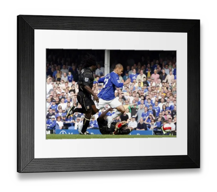 Framed Print : Everton v Portsmouth - James Vaughan is brought down in the box to win a penalty