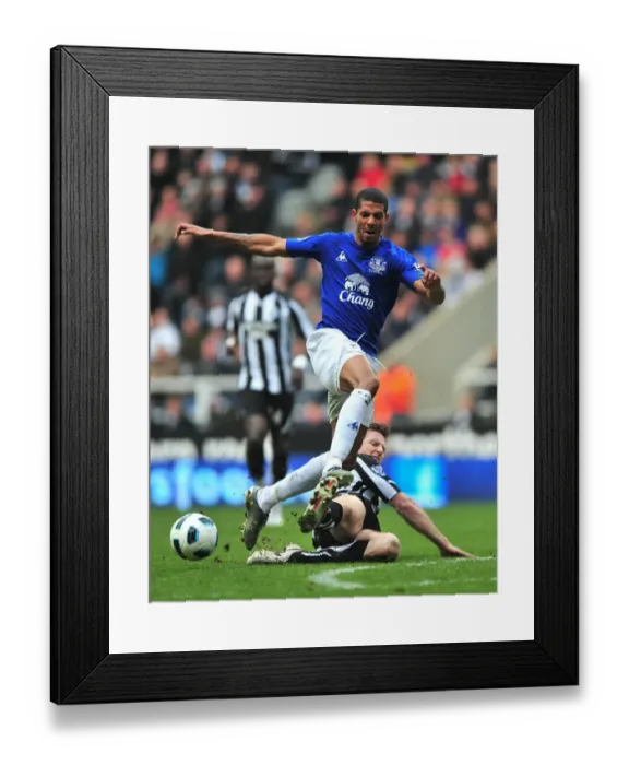 Framed Print : Intense Rivalry: Beckford vs Williamson - Everton vs Newcastle United (05 March 2011): A Battle for Supremacy