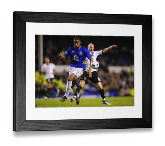 Framed Print : Intense Rivalry: Distin vs. Johnson - Everton vs. Fulham, Premier League Showdown (19 March 2011, Goodison Park)