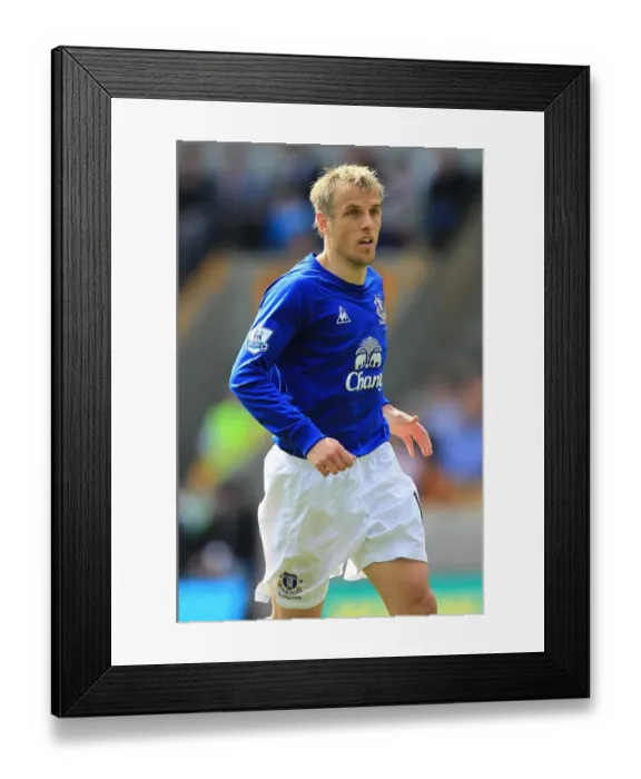 Framed Print : Phil Neville Leads Everton Against Wolverhampton Wanderers in the Barclays Premier League (09 April 2011)