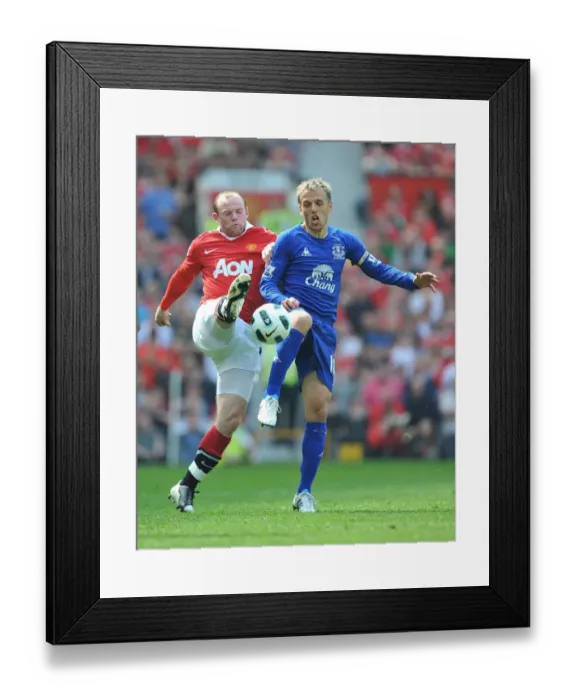 Framed Print : Rooney vs Neville: Clash of Blues and Reds at Old Trafford - Manchester United vs Everton, Barclays Premier League (23 April 2011)