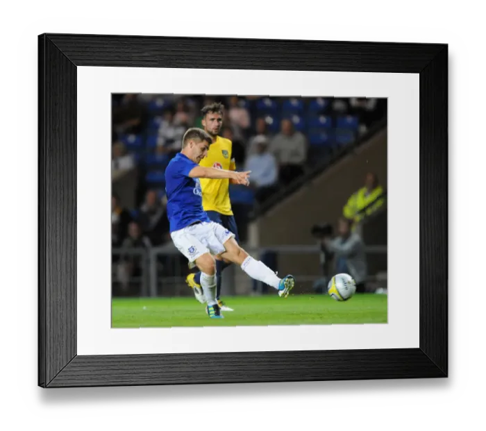 Framed Print : Everton's Luke Garbutt Aims for the Win: Pre-Season Showdown vs. Oxford United at Kassam Stadium (2011)