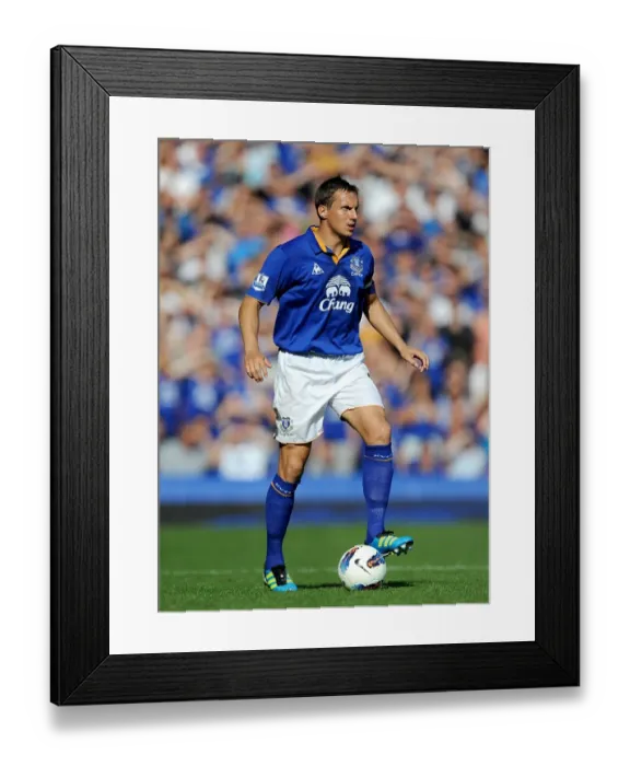 Framed Print : Phil Jagielka vs. Liverpool: Everton's Defender Faces Off in the Intense Everton vs. Liverpool Barclays Premier League Match at Goodison Park (1 October 2011)