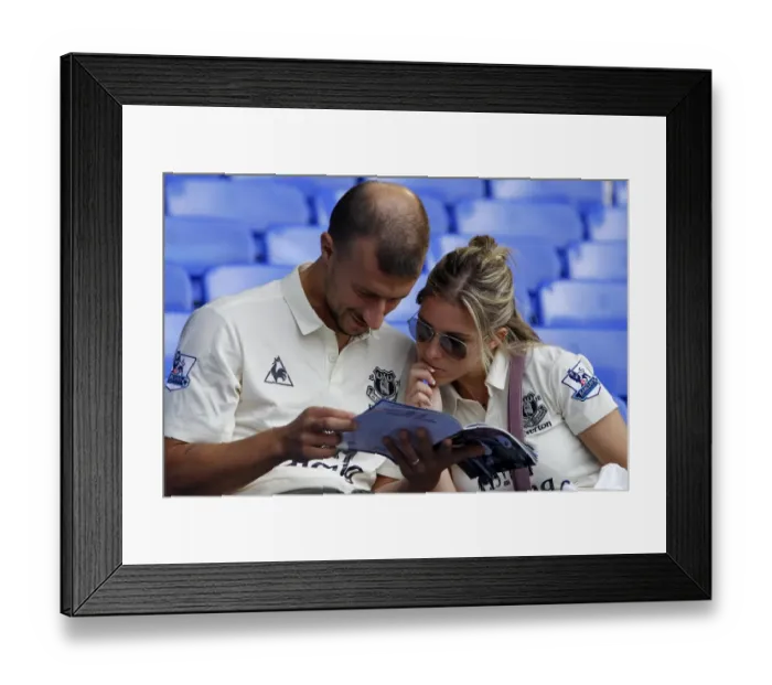 Framed Print : Everton vs. Liverpool Rivalry: Everton Fans Absorbed in Match Programs (Goodison Park, 01.10.2011) Framed Print : Everton vs. Liverpool Rivalry: Everton Fans Absorbed in Match Programs (Goodison Park, 01.10.2011)
