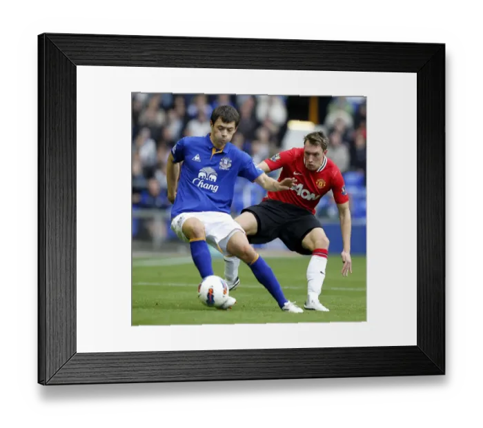 Framed Print : Phil Jones vs Diniyar Bilyaletdinov: A Clash of Talents at Goodison Park, Everton vs Manchester United, Premier League 2011 Framed Print : Phil Jones vs Diniyar Bilyaletdinov: A Clash of Talents at Goodison Park, Everton vs Manchester United, Premier League 2011