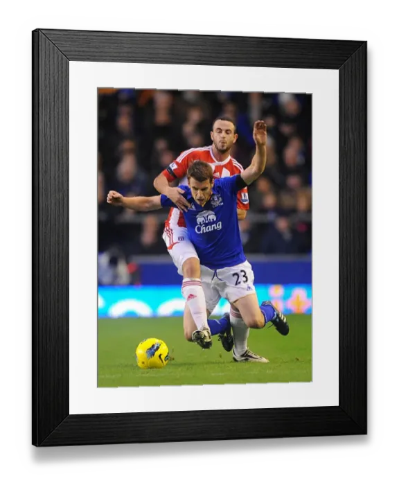 Framed Print : Intense Rivalry: Coleman vs. Wilson - Everton vs. Stoke City, Premier League (2011): A Battle for the Ball Framed Print : Intense Rivalry: Coleman vs. Wilson - Everton vs. Stoke City, Premier League (2011): A Battle for the Ball