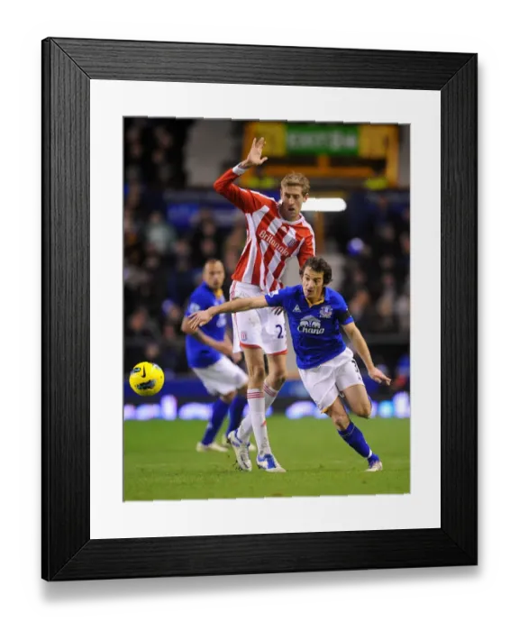 Framed Print : Intense Rivalry: Leighton Baines vs. Peter Crouch's Battle for the Ball at Goodison Park - Everton vs. Stoke City, Barclays Premier League (2011) Framed Print : Intense Rivalry: Leighton Baines vs. Peter Crouch's Battle for the Ball at Goodison Park - Everton vs. Stoke City, Barclays Premier League (2011)