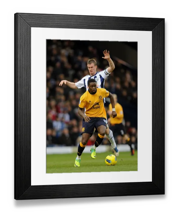 Framed Print : Clash at The Hawthorns: Brunt vs. Gueye - Everton vs. West Bromwich Albion (01.01.2012) - Premier League Showdown Framed Print : Clash at The Hawthorns: Brunt vs. Gueye - Everton vs. West Bromwich Albion (01.01.2012) - Premier League Showdown