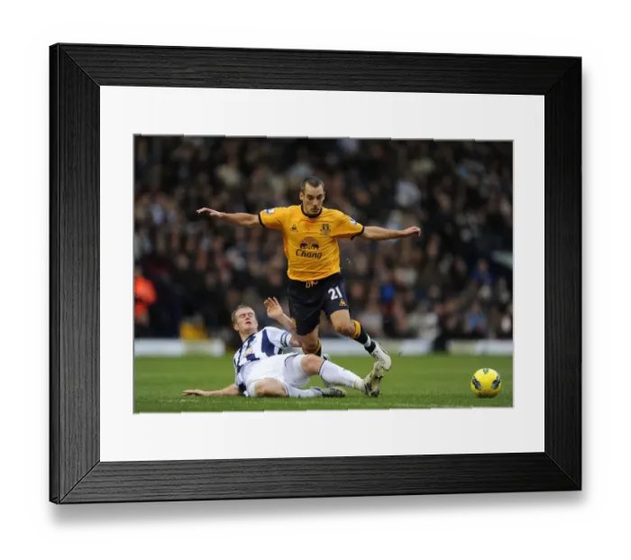 Framed Print : Intense Tackle: Chris Brunt vs. Leon Osman - Barclays Premier League Clash (01 January 2012) Framed Print : Intense Tackle: Chris Brunt vs. Leon Osman - Barclays Premier League Clash (01 January 2012)