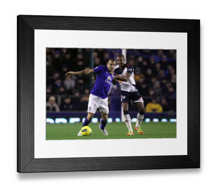 Framed Print : A Battle for the Ball: Heitinga vs Ngog at Goodison Park - Everton vs Bolton Wanderers (Barclays Premier League, 04 January 2012)