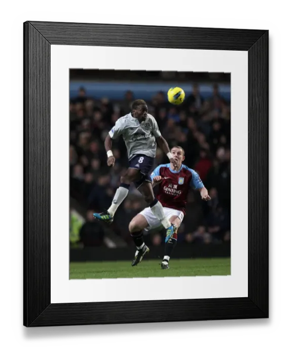 Framed Print : Intense Battle: Saha vs Dunne - Everton vs Aston Villa, Premier League (2012): A Clash of Titans at Villa Park