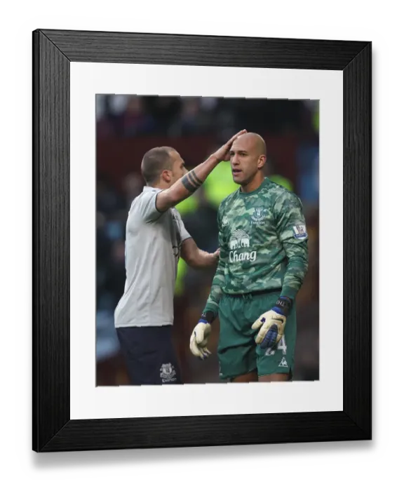 Framed Print : Everton's Heitinga Comforts Howard: A Moment of Solidarity on the BPL Battlefield (14 January 2012, Aston Villa vs. Everton)