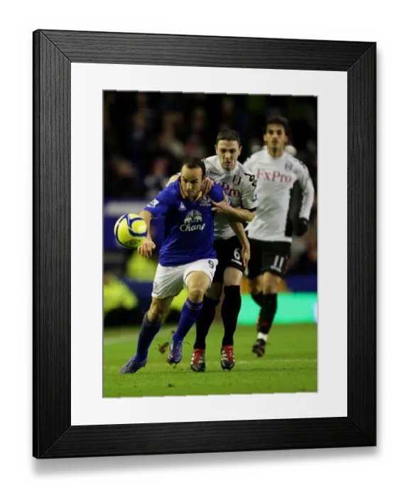 Framed Print : Everton's Landon Donovan Slips Past Chris Baird in FA Cup Showdown at Goodison Park Framed Print : Everton's Landon Donovan Slips Past Chris Baird in FA Cup Showdown at Goodison Park