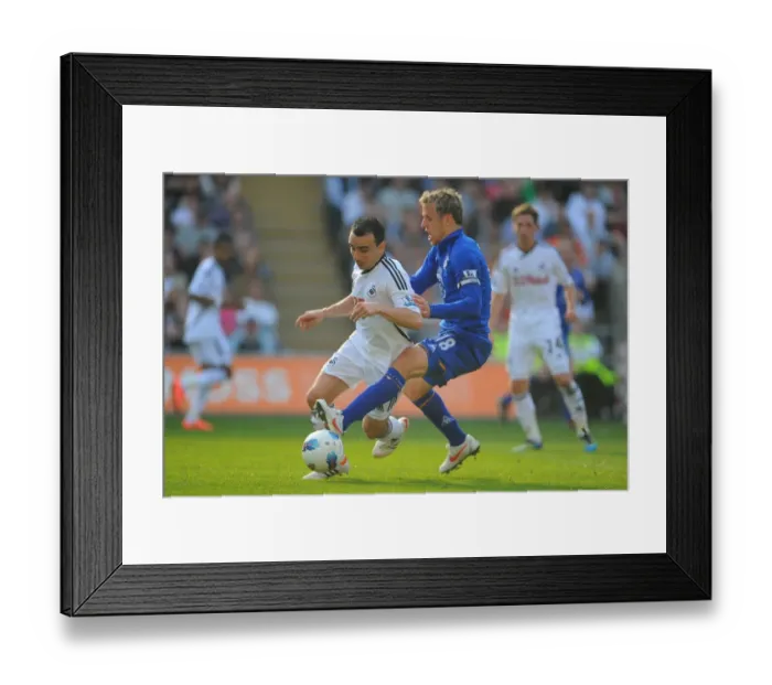 Framed Print : Intense Rivalry: Phil Neville vs. Leon Britton - Everton vs. Swansea City Clash in the Barclays Premier League (24 March 2012, Liberty Stadium) Framed Print : Intense Rivalry: Phil Neville vs. Leon Britton - Everton vs. Swansea City Clash in the Barclays Premier League (24 March 2012, Liberty Stadium)