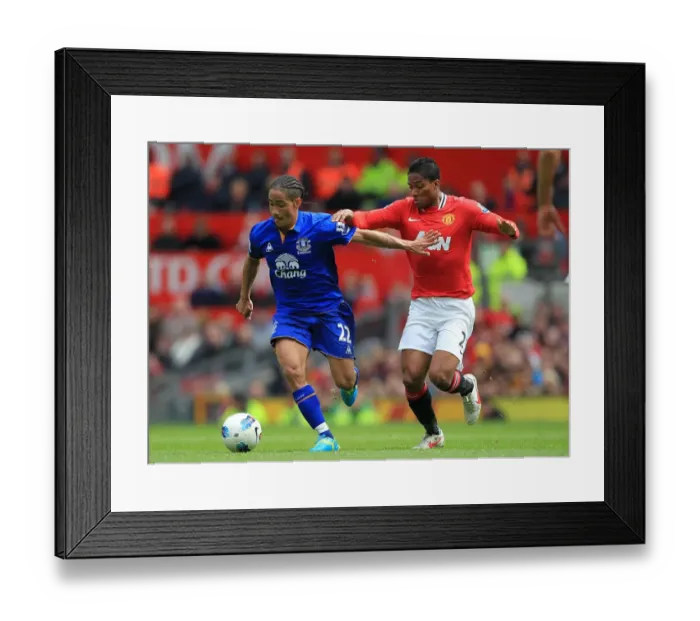 Framed Print : Battle for the Ball: Valencia vs. Pienaar - Premier League Rivalry: Manchester United vs. Everton (22 April 2012, Old Trafford) Framed Print : Battle for the Ball: Valencia vs. Pienaar - Premier League Rivalry: Manchester United vs. Everton (22 April 2012, Old Trafford)