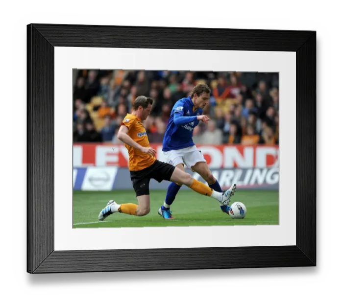 Framed Print : Jelavic vs. Stearman: A Tense Showdown in the Everton vs. Wolverhampton Wanderers Premier League Clash