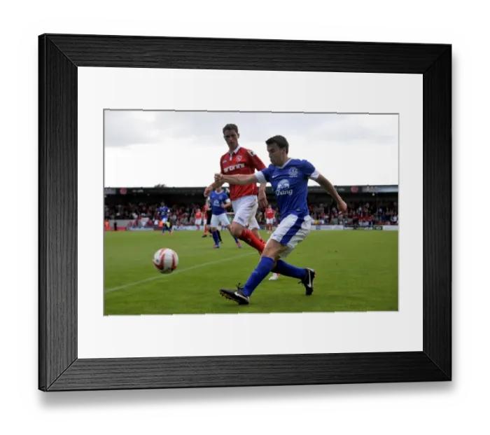 Framed Print : Seamus Coleman vs. Gary McDonald: Intense Clash between Everton's Star and Morecambe's Star Player during Pre-Season Friendly
