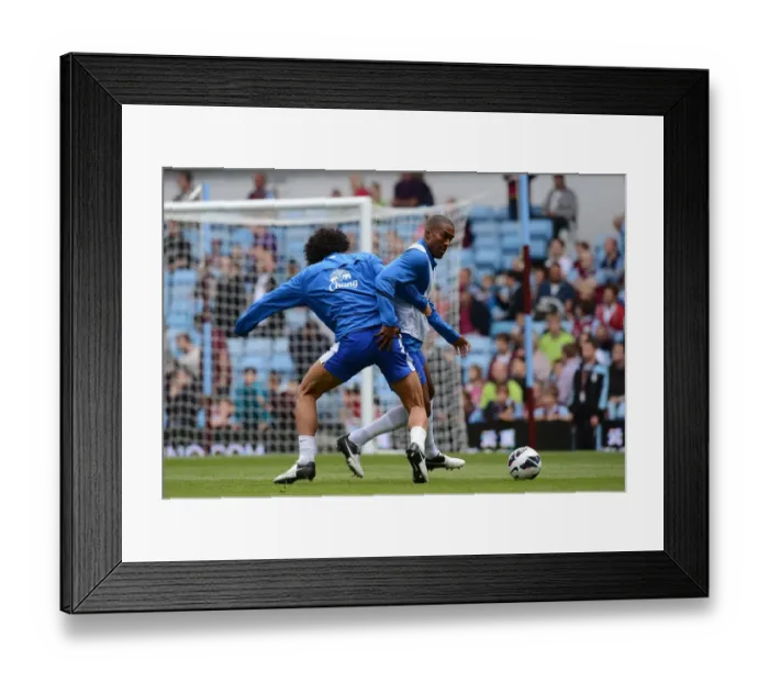 Framed Print : Fellaini vs. Distin: Intense Rivalry Unfolds in Everton's Warm-Up at Villa Park Framed Print : Fellaini vs. Distin: Intense Rivalry Unfolds in Everton's Warm-Up at Villa Park