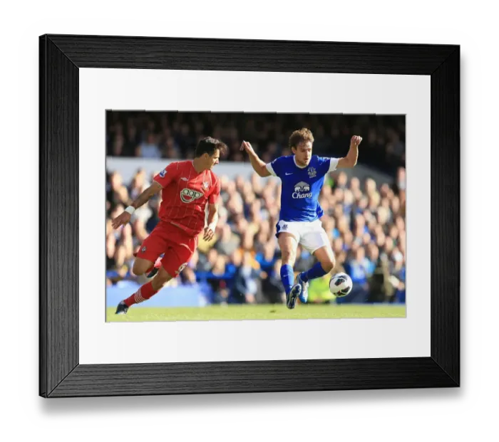 Framed Print : Everton's Battle for Ball Supremacy: Jelavic vs Fonte (3-1) Framed Print : Everton's Battle for Ball Supremacy: Jelavic vs Fonte (3-1)
