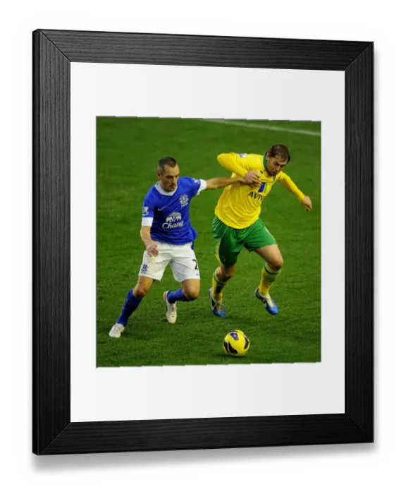 Framed Print : Battle for the Ball: Osman vs. Holt - Everton vs. Norwich City's Thrilling 1-1 Premier League Showdown at Goodison Park Framed Print : Battle for the Ball: Osman vs. Holt - Everton vs. Norwich City's Thrilling 1-1 Premier League Showdown at Goodison Park