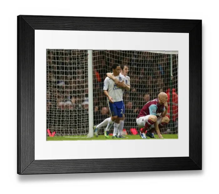 Framed Print : Everton's Double Strike: Pienaar and Baines Celebrate as Collins Looks On in Disappointment (Everton 2-1 West Ham, Upton Park, 2012) Framed Print : Everton's Double Strike: Pienaar and Baines Celebrate as Collins Looks On in Disappointment (Everton 2-1 West Ham, Upton Park, 2012)