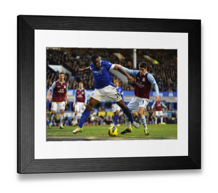 Framed Print : Battle at Goodison Park: Anichebe vs. Westwood - Everton vs. Aston Villa's Thrilling 3-3 Encounter Framed Print : Battle at Goodison Park: Anichebe vs. Westwood - Everton vs. Aston Villa's Thrilling 3-3 Encounter
