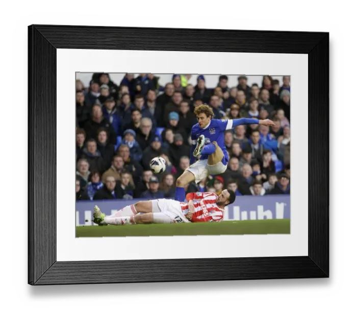 Framed Print : Marc Wilson's Sliding Tackle on Nikica Jelavic: Everton's 1-0 Win Over Stoke City at Goodison Park (March 30, 2013)
