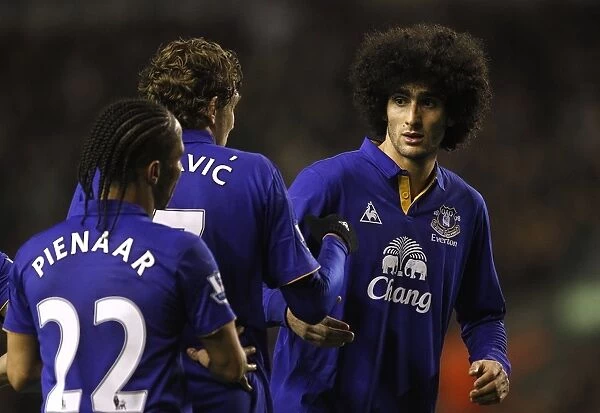 Three Amigos in Deep Conversation: Pienaar, Jelavic, and Fellaini at Anfield during Everton's BPL Clash with Liverpool (13 March 2012)