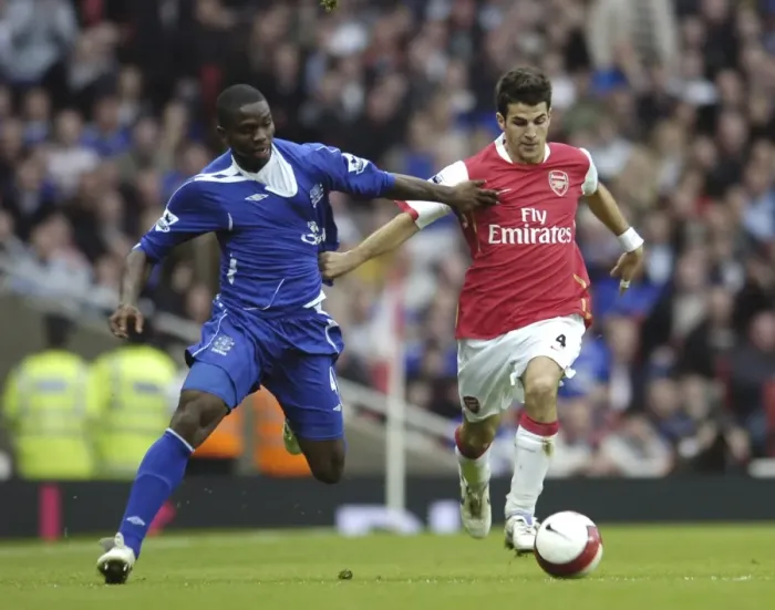 Framed Print : Arsenal v Everton Arsenals Francesc Fabregas and Evertons Joseph Yobo in action