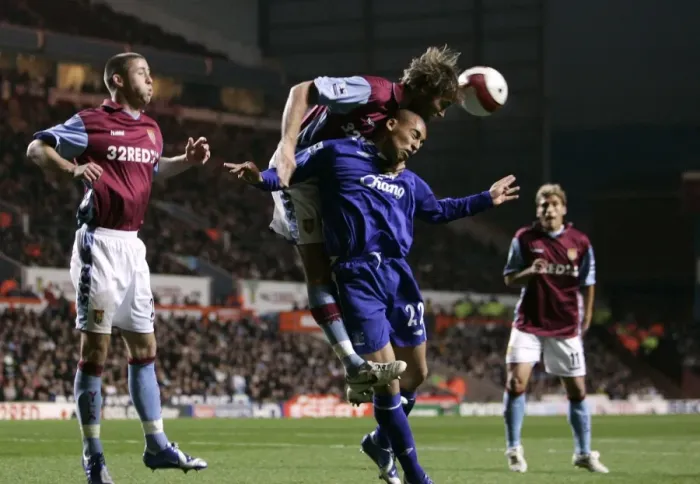 Framed Print : Aston Villa v Everton James Vaughan in action against Olof Mellberg