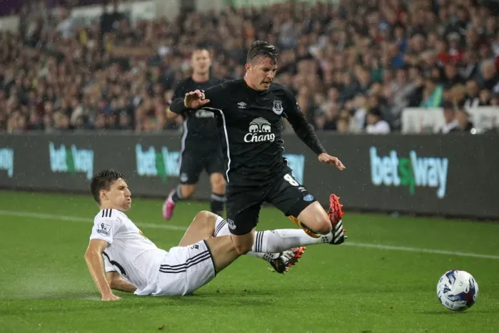 Framed Print : Battling for Control: Oviedo vs. Fernandez in the Intense Capital One Cup Clash between Swansea City and Everton Framed Print : Battling for Control: Oviedo vs. Fernandez in the Intense Capital One Cup Clash between Swansea City and Everton