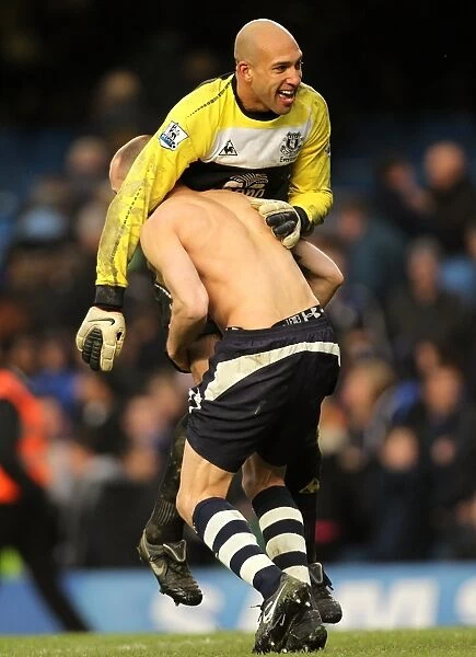Celebrating Glory: Heitinga and Howard's FA Cup Upset Victory Jubilation at Stamford Bridge (19 February 2011)