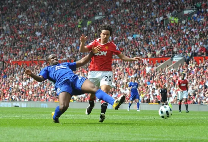 Framed Print : Clash at Old Trafford: Anichebe vs Fabio - A Goal-line Battle in the Premier League Showdown (23 April 2011)