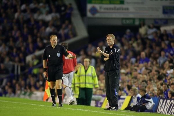 David Moyes. Moyes passes on a message, eagerly watched by the assistant referee