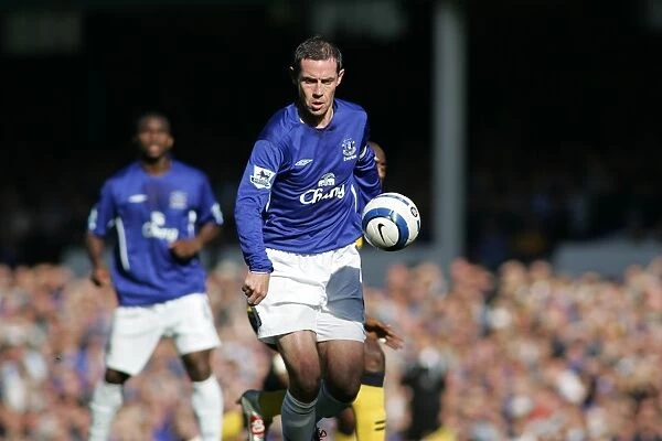 David Weir: Guarding Everton's Turf - Shielding the Ball from Wigan's Advance