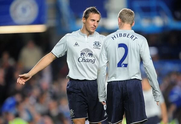 Deep in Thought: Hibbert and Jagielka's Intense Conversation at Stamford Bridge during Chelsea vs Everton (15 October 2011)