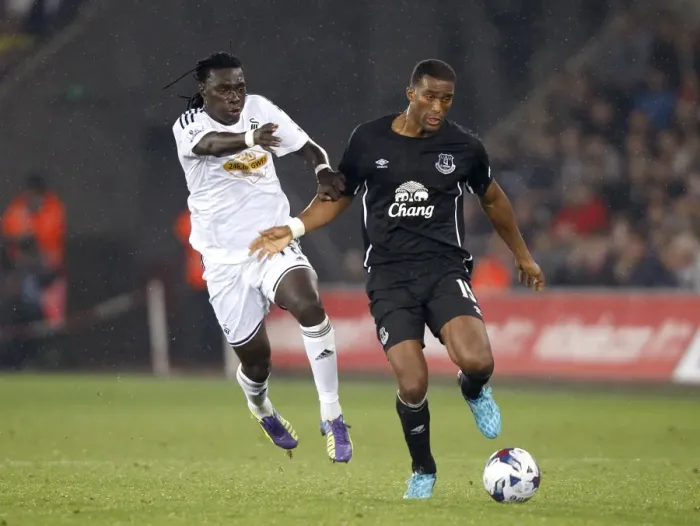 Framed Print : Distin vs. Gomis: A Battle for the Ball in Everton's Capital One Cup Clash at Swansea