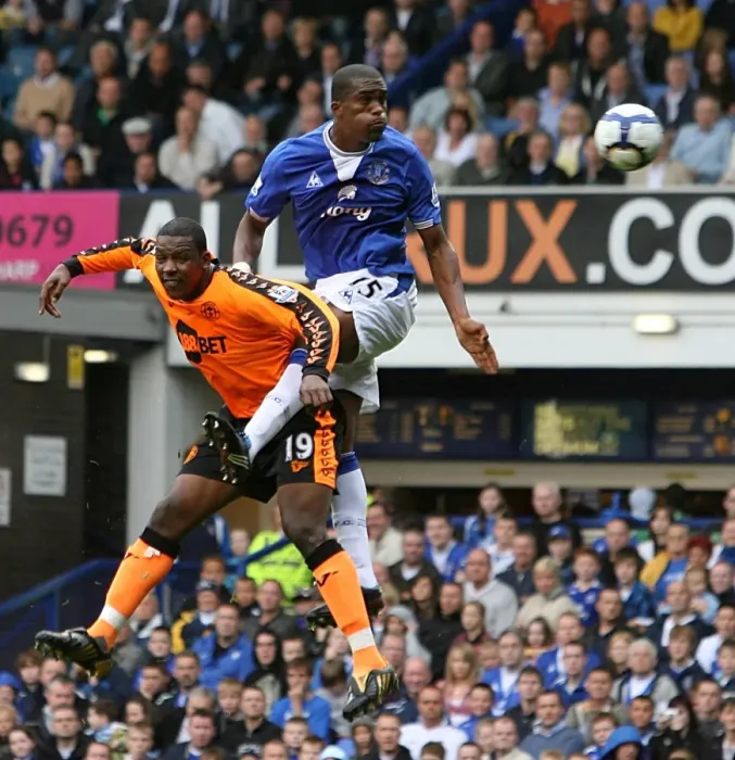 Framed Print : Distin's Dominance: Everton's Sylvain Distin Outjumps Wigan's Titus Bramble in Premier League Showdown at Goodison Park Framed Print : Distin's Dominance: Everton's Sylvain Distin Outjumps Wigan's Titus Bramble in Premier League Showdown at Goodison Park