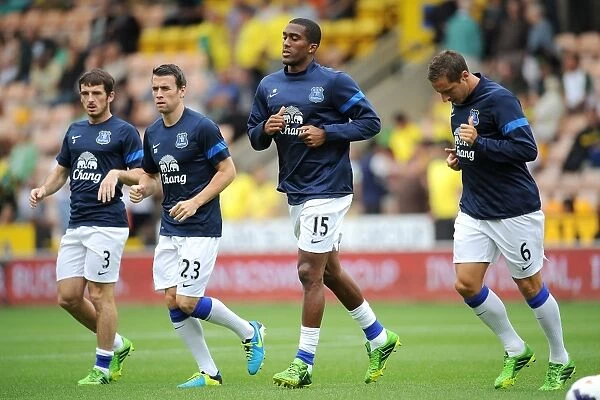 Everton Squad Gearing Up: Leighton Baines, Seamus Coleman, Sylvain Distin, and Phil Jagielka in Pre-Match Warm-Up vs Norwich City, August 2013 (Carrow Road)