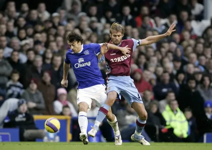 Framed Print : Everton v Aston Villa Evertons Simon Davies in action against Aston Villas Olof Mellberg