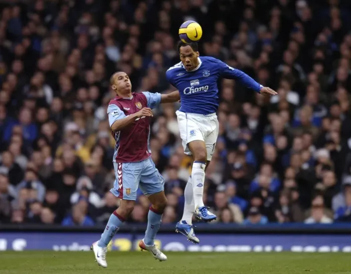 Framed Print : Everton v Aston Villa Joleon Lescott wins a header against Gabriel Agbonlahor