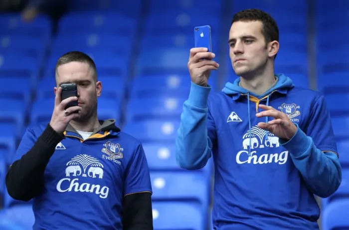 Framed Print : Everton vs Manchester United: Fans Capturing the Action at Goodison Park (2011) - Two Fans Taking Pictures with Mobile Phones during the Barclays Premier League Match Framed Print : Everton vs Manchester United: Fans Capturing the Action at Goodison Park (2011) - Two Fans Taking Pictures with Mobile Phones during the Barclays Premier League Match