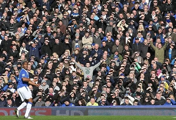Everton vs Manchester United: Everton Fans Shield Eyes from Sun at Goodison Park