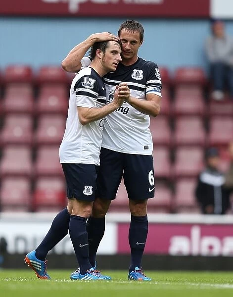 Everton's Glory: Leighton Baines and Phil Jagielka Celebrate a Thrilling 3-2 Victory over West Ham in the Premier League (September 21, 2013)