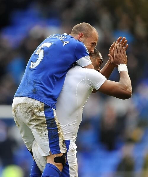 Everton's Heitinga and Distin: Celebrating Victory Over Manchester City at Goodison Park (16-03-2013)