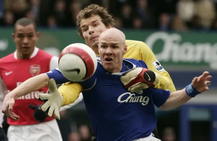 Framed Print : Evertons Johnson challenges Arsenals Lehmann for the ball during their English Premier League socc