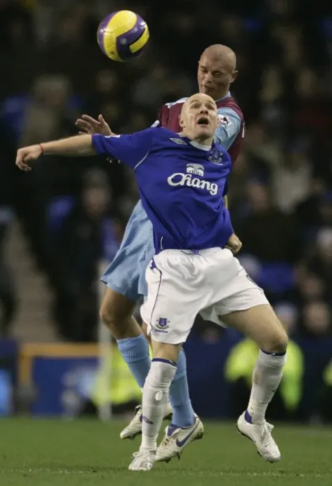 Framed Print : Evertons Johnson challenges West Ham Uniteds Konchesky for the ball during their English Premier L Framed Print : Evertons Johnson challenges West Ham Uniteds Konchesky for the ball during their English Premier L