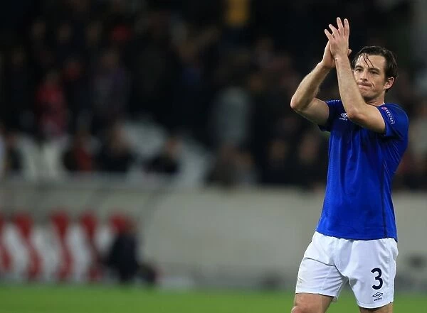 Everton's Leighton Baines Celebrates UEFA Europa League Victory Over Lille OSC and Acknowledges Adoring Fans